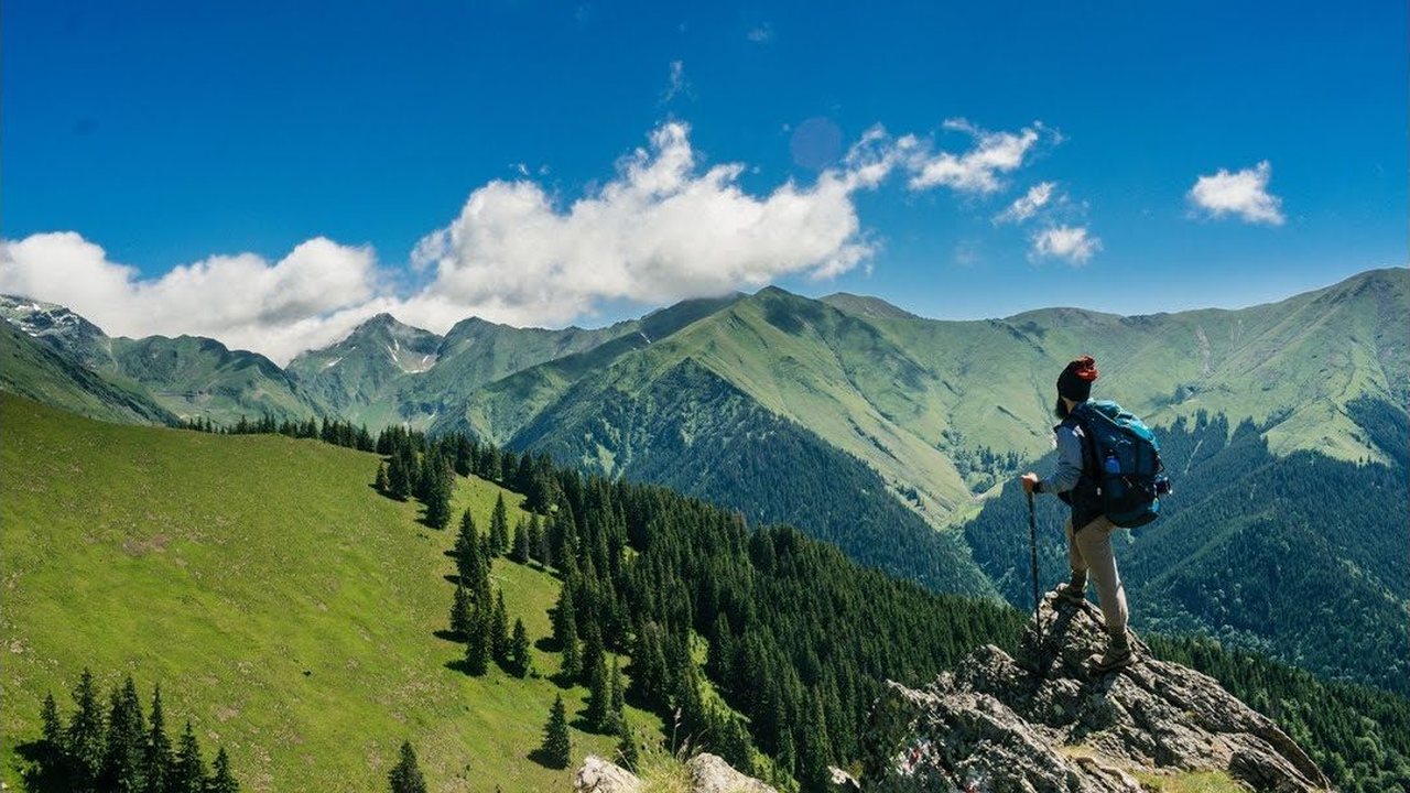 A hiker on a mountain ridge — still frame from the meet-your-counselor video